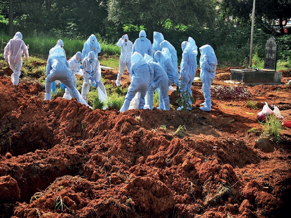 Volunteers of Mercy Angels conduct the last rites for covid patients at a burial ground on Nandi Durga Road.