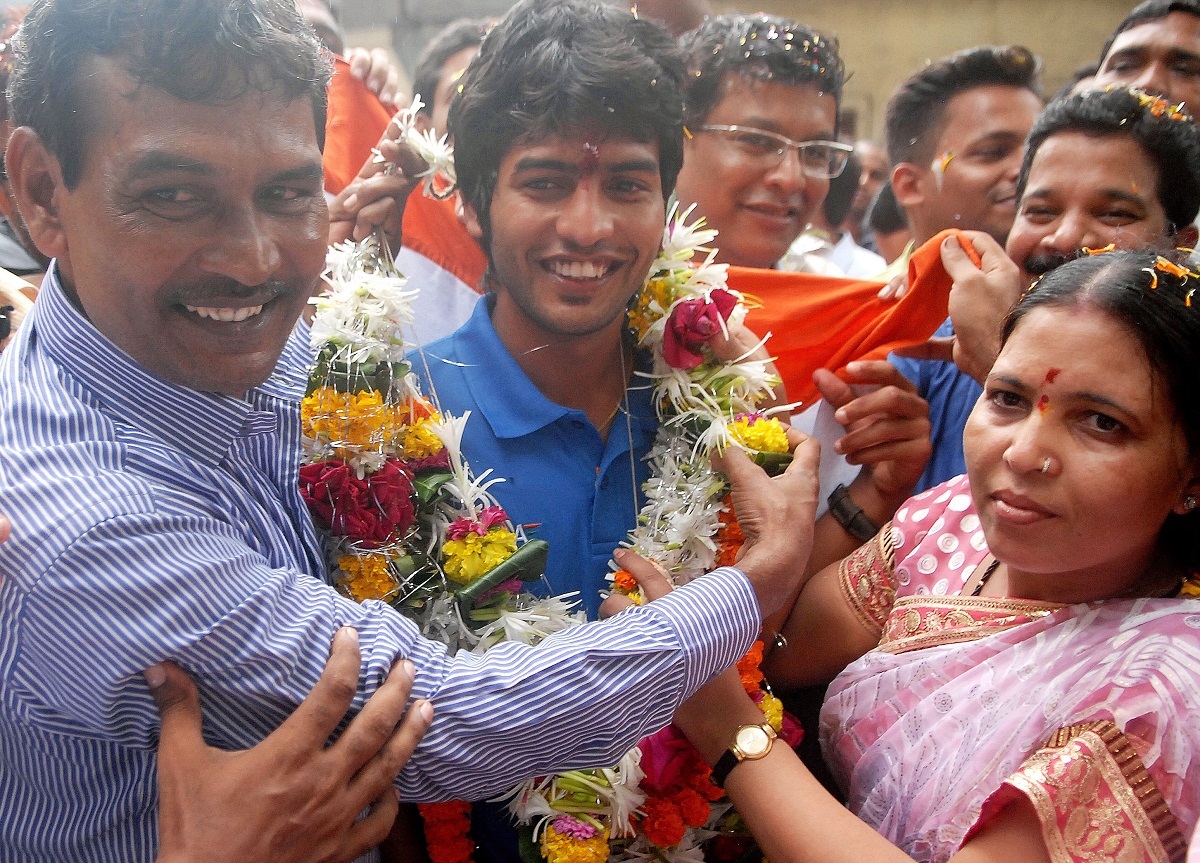 Yuvraj Walmiki with his parents. Photo: BCCL