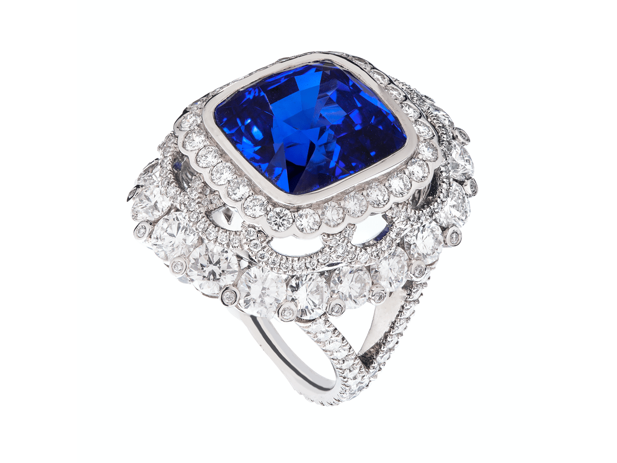 Platinum ring set with a 13.01-carat blue sapphire with a surround of round diamonds by Faberge