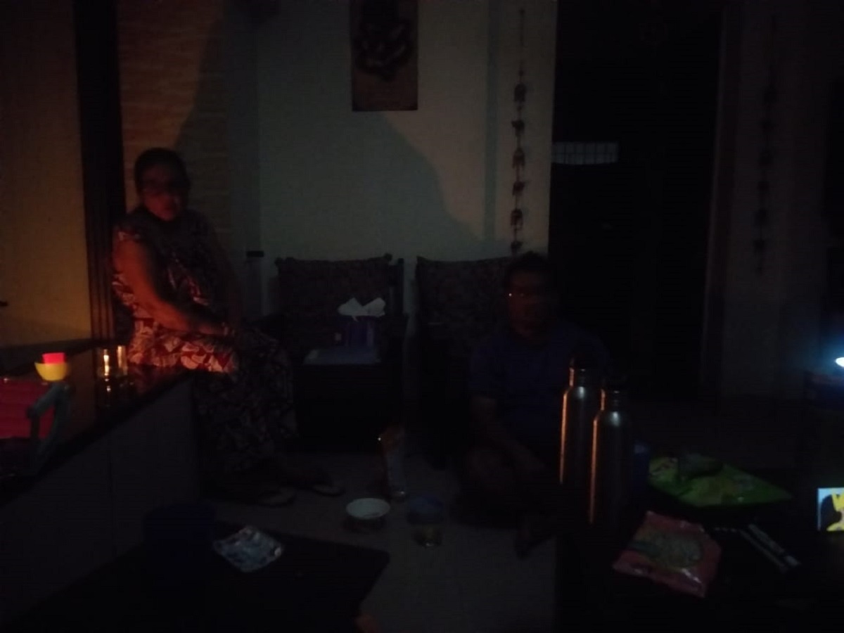 Residents sit in the dark waiting for power to return to the Balkum area.