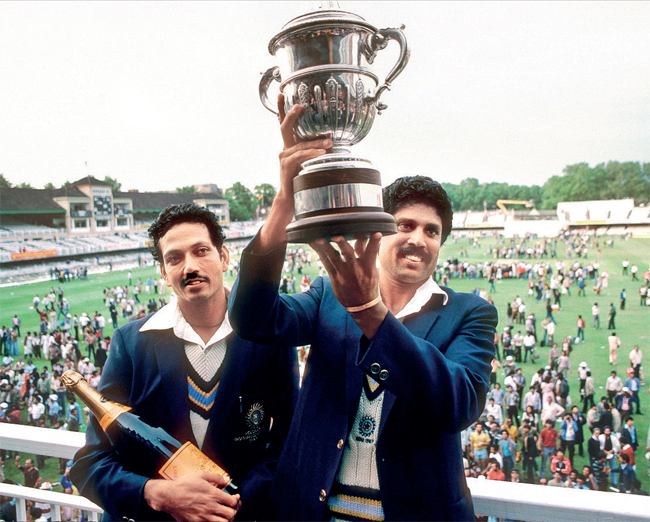 Kapil Dev lifts the trophy as Man of the Match Mohinder Armanath looks on after winning the 1983 World Cup final against the West Indies at Lords on June 25, 1983 in London, England (GET IMAGES)