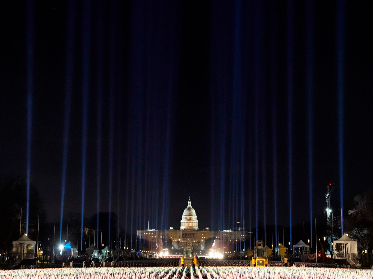 Blue lights are beamed into the sky over the &#39;Field of Flags&#39; on the National Mall AFP 1200