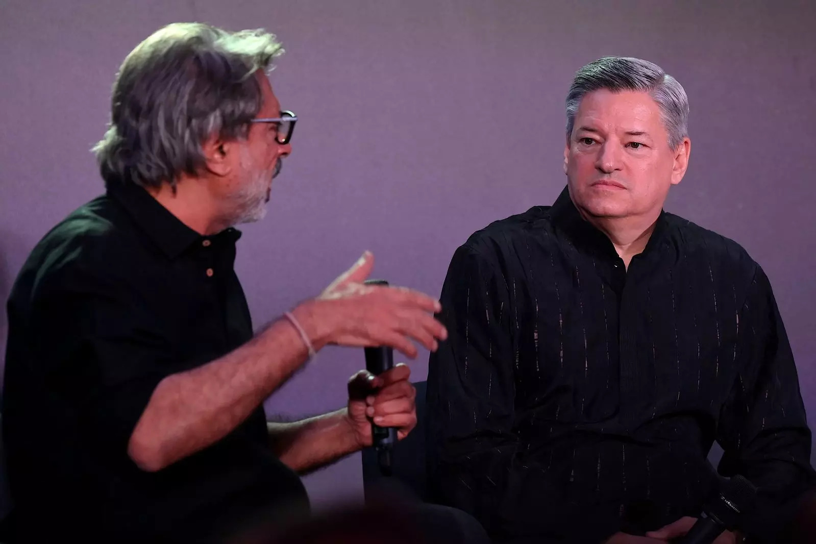 Bollywood director, screenwriter and music composer Sanjay Leela Bhansali (L) along with Co-chief executive officer of Netflix, Ted Sarandos (R) speak during an event in Mumbai on February 18, 2023. (Photo by SUJIT JAISWAL / AFP)