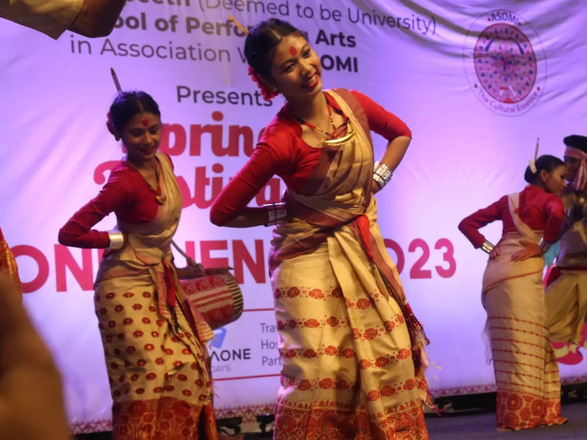 Assamese artists performing Bihu on stage