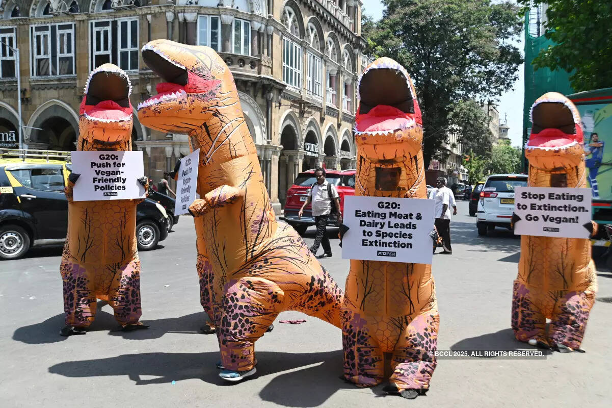 Volunteers dress up as dinosaurs to embrace veganism