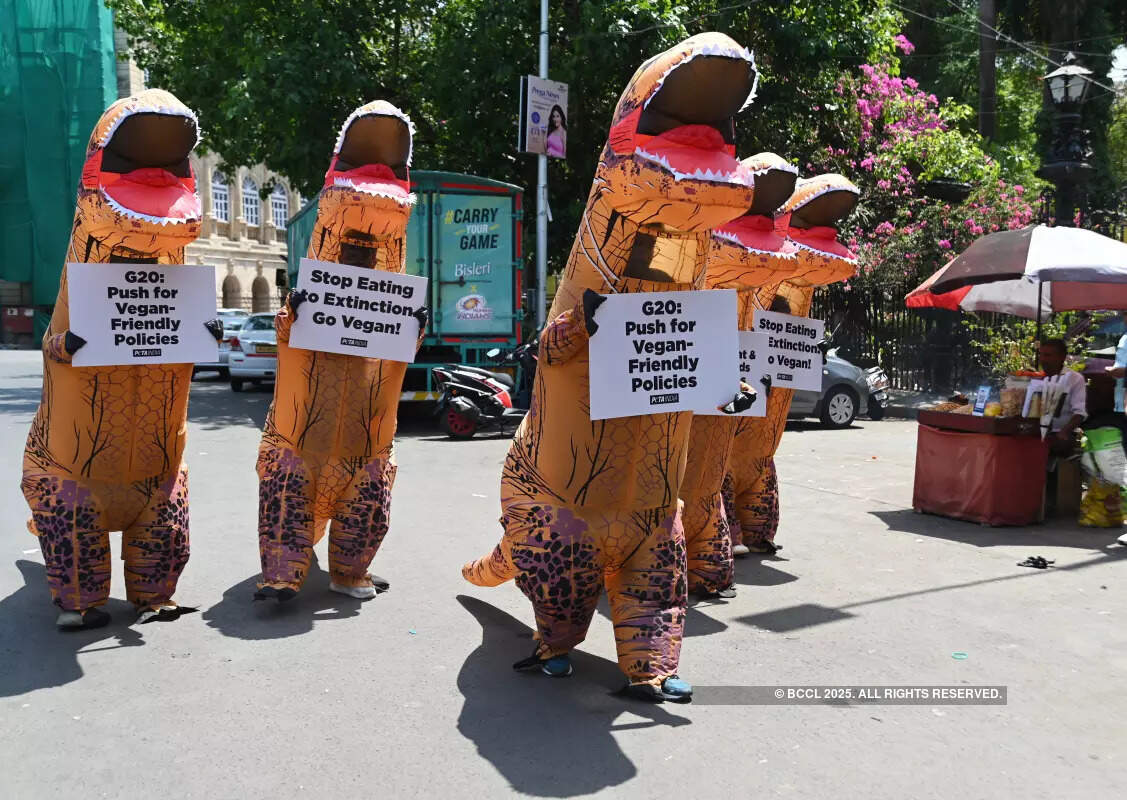 Volunteers dress up as dinosaurs to embrace veganism