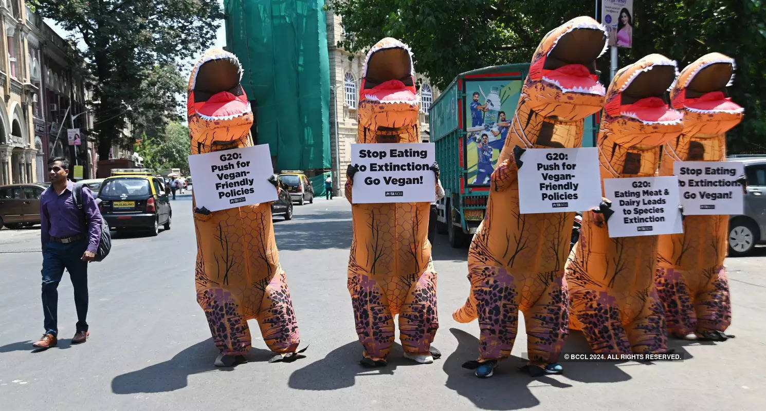 Volunteers dress up as dinosaurs to embrace veganism