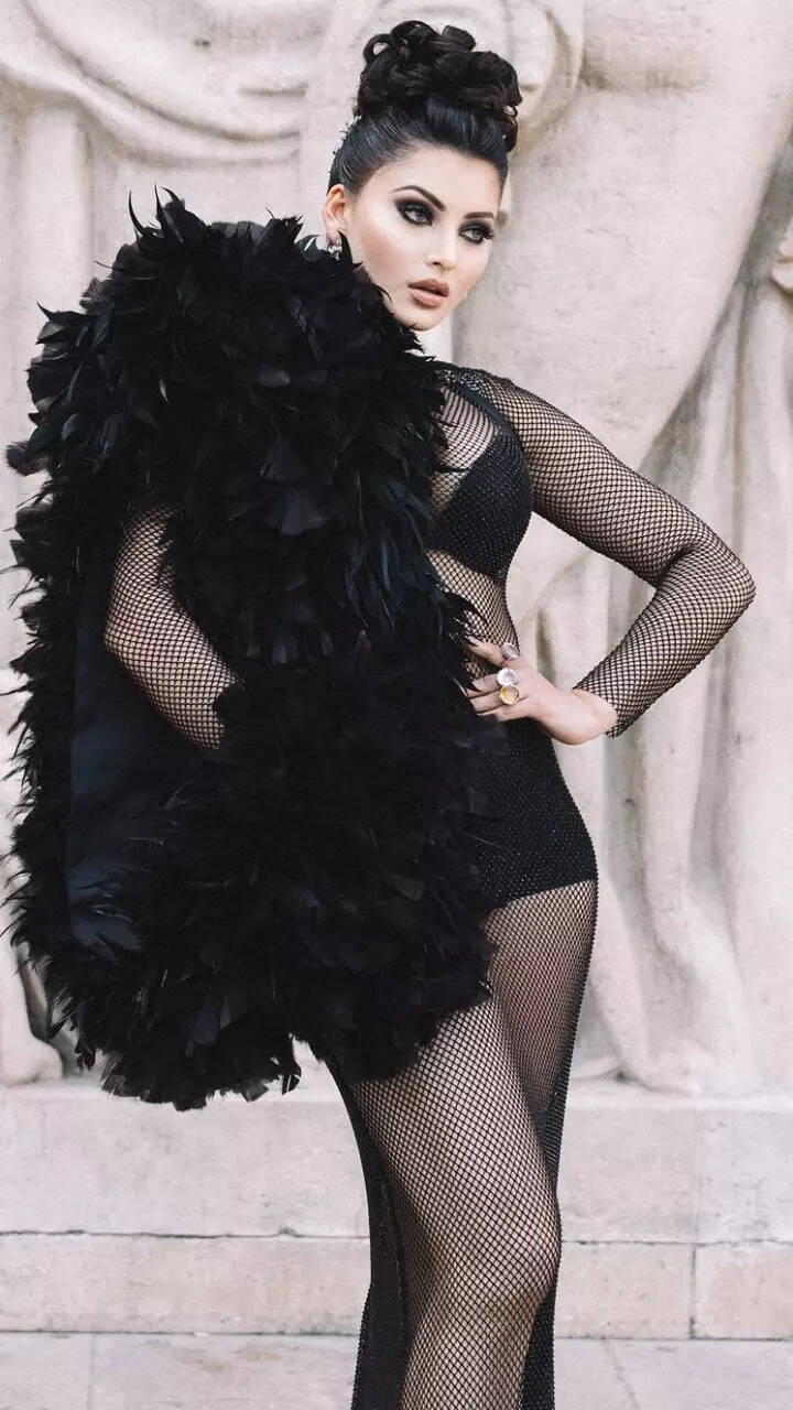 Urvashi Rautela commands attention at PFW in black net dress with dramatic feather sleeve