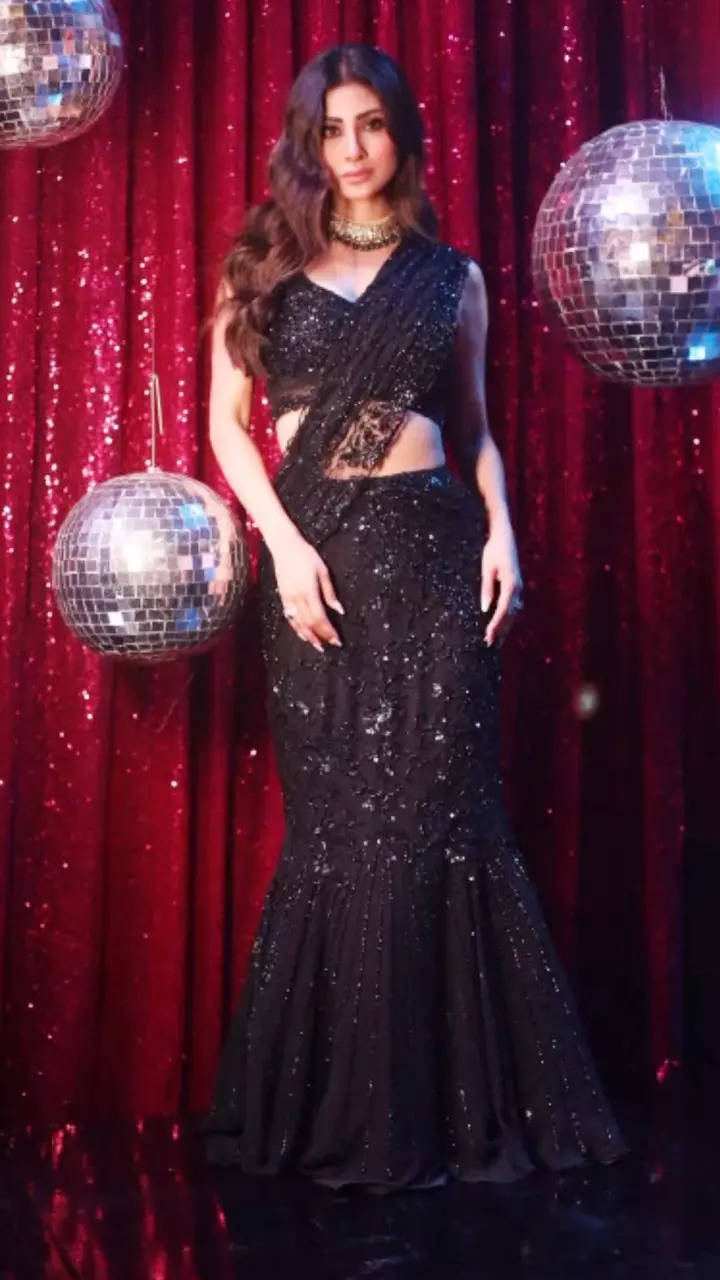 Mouni Roy shines bright in a black shimmery fishtail saree