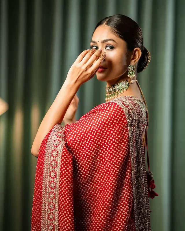 Mrunal Thakur looks radiant in a timeless red saree, sets ethnic style bar high in stunning pictures