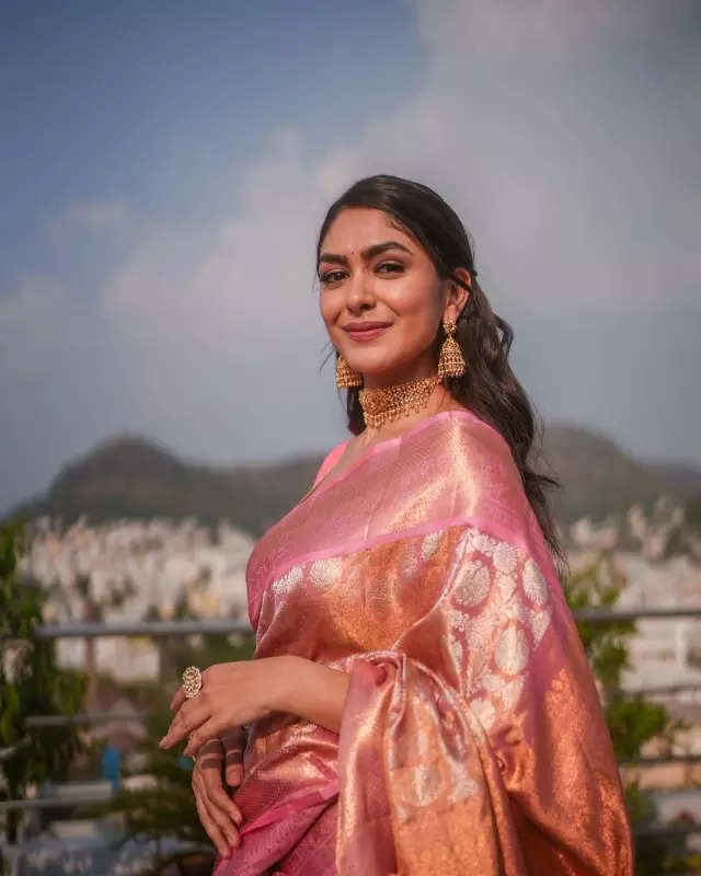 Mrunal Thakur looks radiant in a timeless red saree, sets ethnic style bar high in stunning pictures