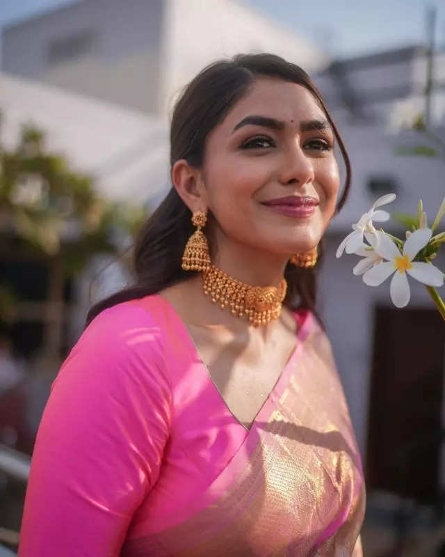 Mrunal Thakur looks radiant in a timeless red saree, sets ethnic style bar high in stunning pictures