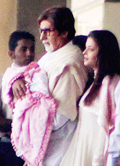 Amitabh Bachchan carries his new born grand-daughter along with his daughter-in-law Aishwarya Rai.