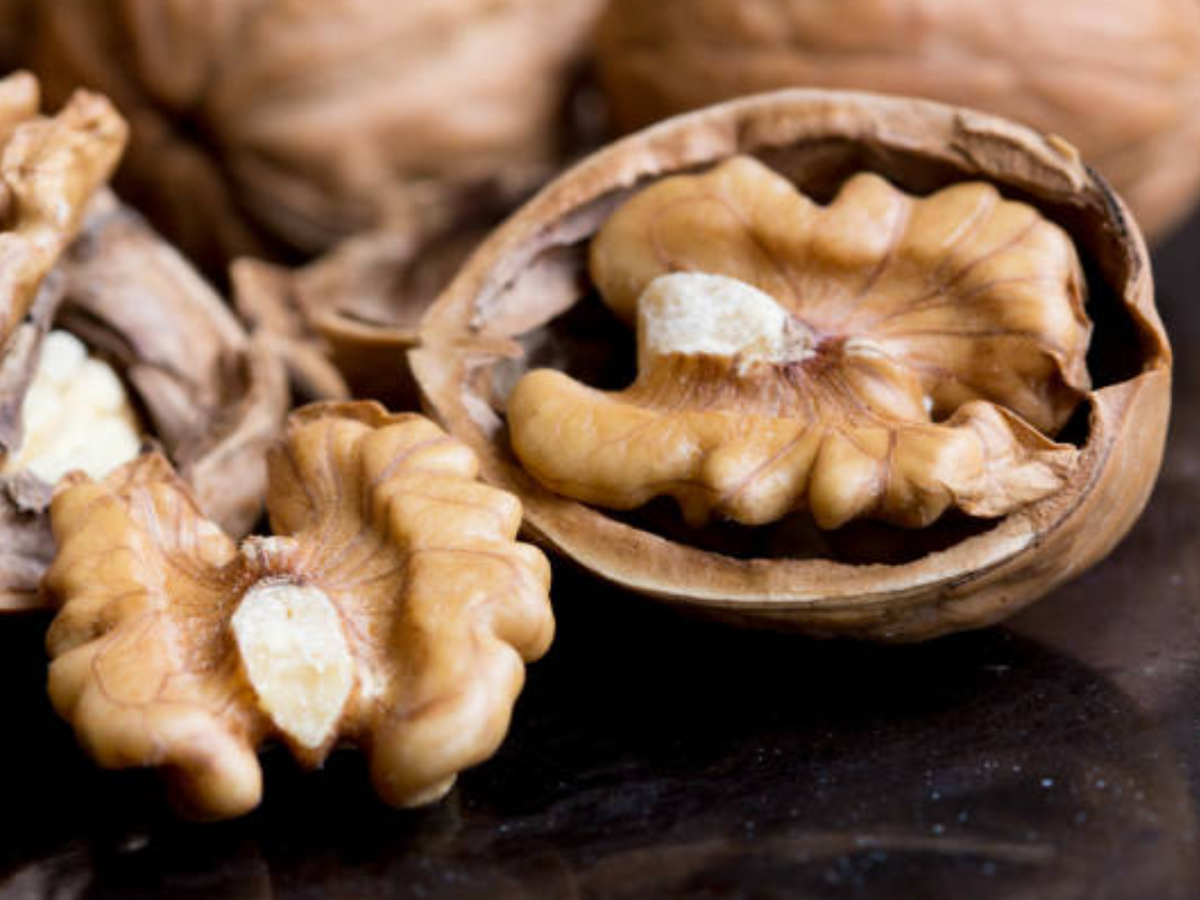 Why is it important to soak walnuts before eating?
