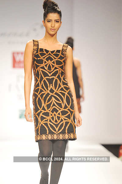 A model walks the ramp to showcase a creation by designer Reynu Tandon ...