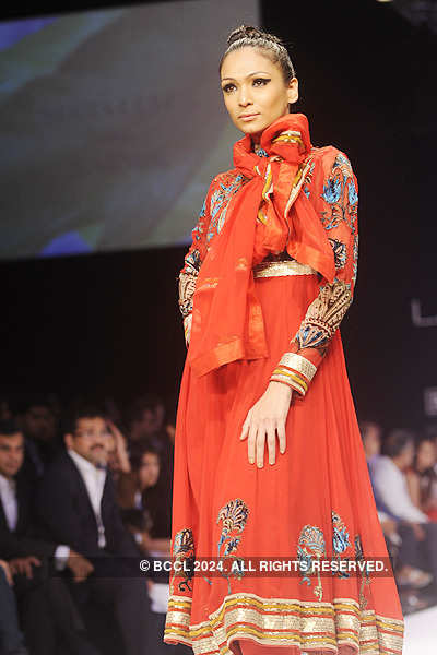 A model walks the ramp to showcase a creation during 'The Karmik Show ...
