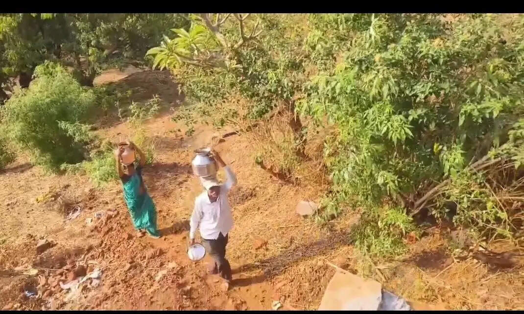 Tribal women brave fall risk in water walk on steep hillsides
