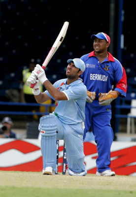 Mahendra Dhoni, right, hits to the boundary before being caught out during the Group B Cricket World Cup match between India and Bermuda at the Queen's Park Oval in Port-of-Spain, Trinidad Monday,