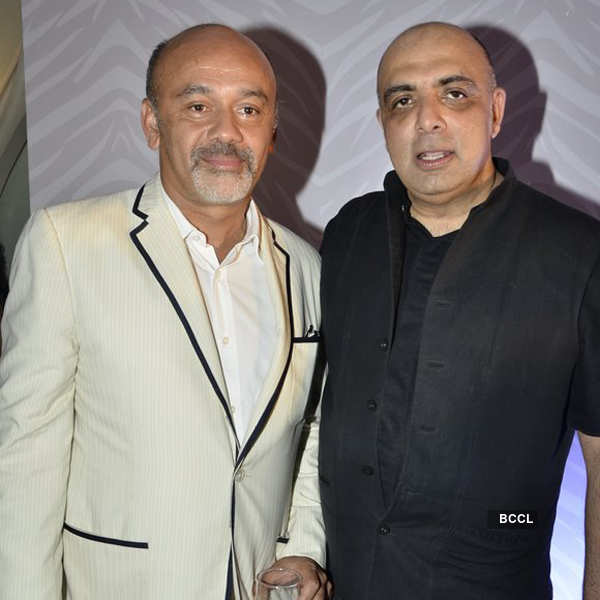 French shoe designer Christian Louboutin poses with his award at
