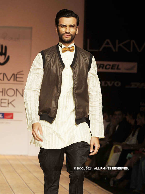 A model walks the ramp to showcase a creation by designer Kunal Rawal ...