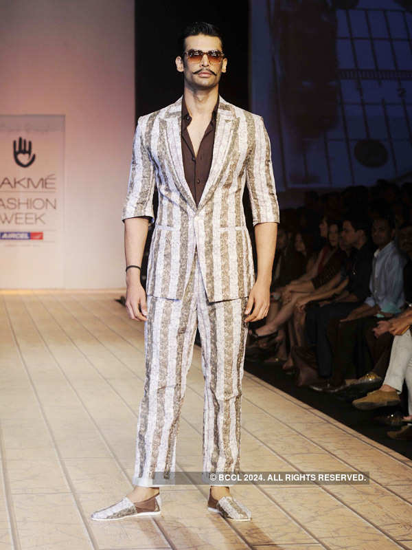 A model walks the ramp to showcase a creation by designer Kunal Rawal ...