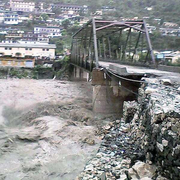 A view of the collapsed bridge over the flooded Alakhnanda River on ...