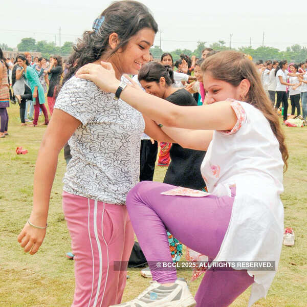 Students emulate their trainers and practice how to kick someone in the