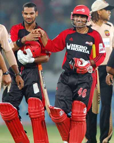 Daredevils' captain Virender Sehwag along with teammate Shikhar Dhawan  coming back to pavilion after successfully chasing the target set by Deccan  Chargers at the IPL T20 match at Rajiv Gandhi International Stadium