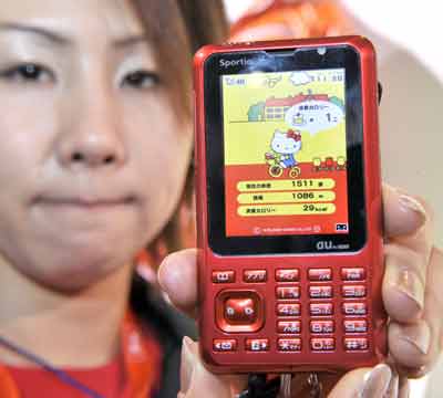Employees of Japan's mobile operator KDDI display a new mobile