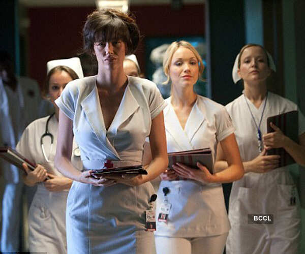 Paz de la Huerta in a latex leotard, red stockings and a glove