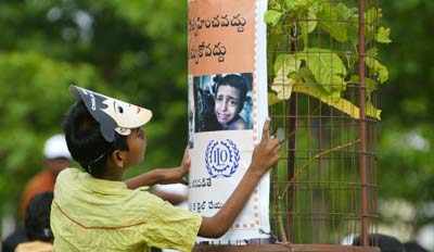 A Kid Looks At The Campaign Poster Of The Awareness Run As The World Marks June 12 As The World Day Against Child Labour Photogallery