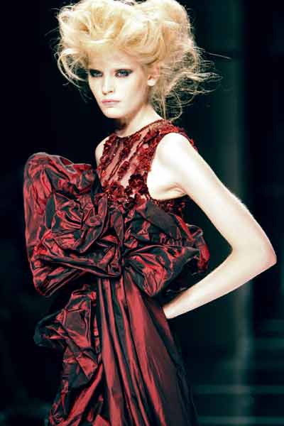Lebanese designer Elie Saab waves to the public at the end of Fall ...