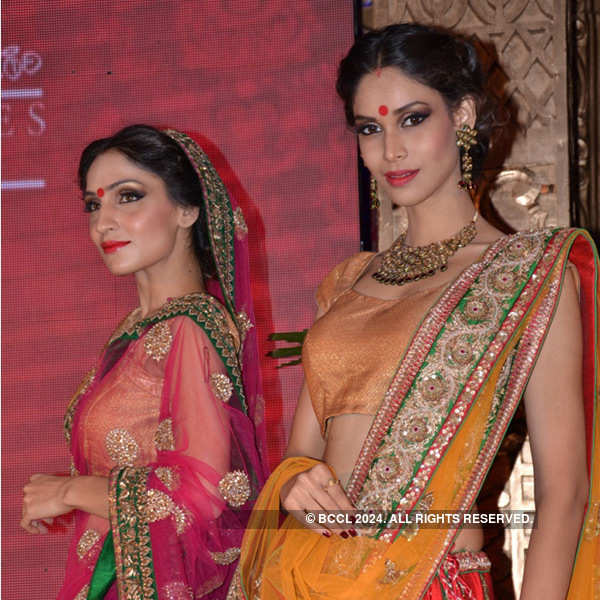 Models walk the ramp during a fashion show presented by 