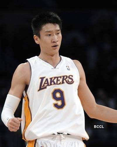 Los Angeles Lakers guard Sun Yue (9), of China, celebrates after scoring  his first NBA points on a jumper against Milwaukee Bucks center Francisco  Elson (9) during the fourth quarter of the