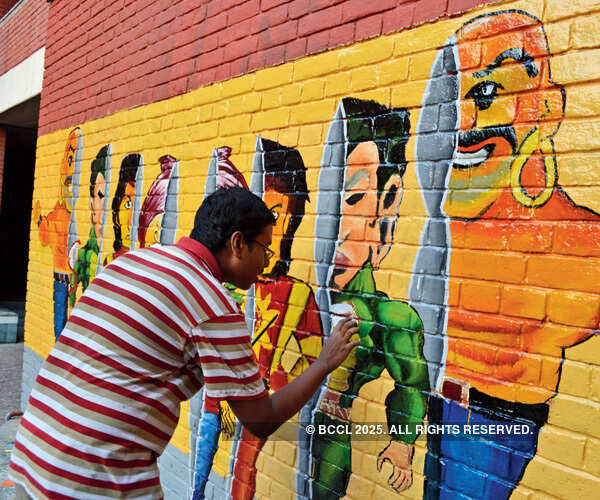 Student painting wall at the annual cultural festival of IIT-Kanpur, Antaragni 2014.