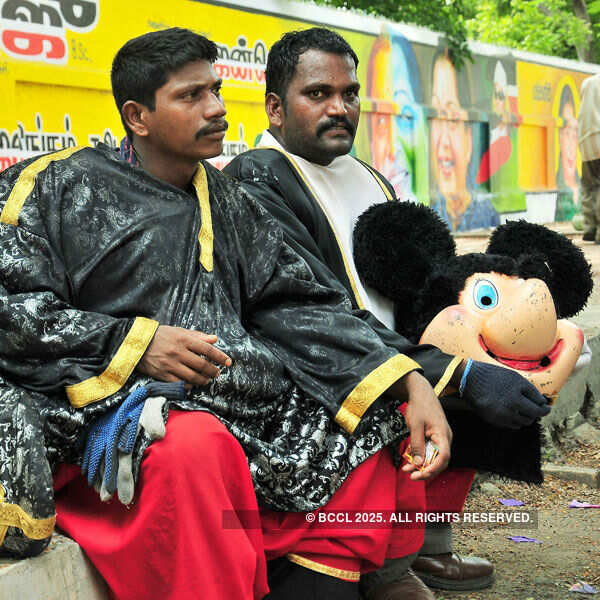 All in day's work: The two clowns take a short break amidst the tasking jubilation Photogallery - Times of India