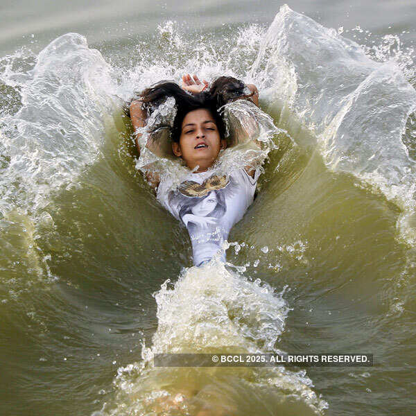A girl cools off herself in the waters of the river Ganges  Photogallery Times of India