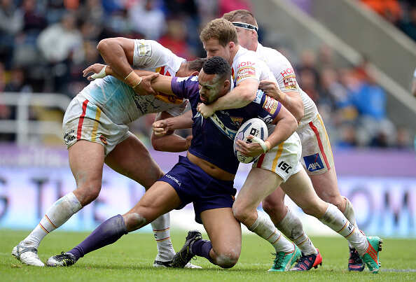 Olivier Elima (L) Remi Casta (R) and Scott Dureau of Catalans Dragons tackle Jodie Broughton of Huddersfield Giants Photogallery - Times of India