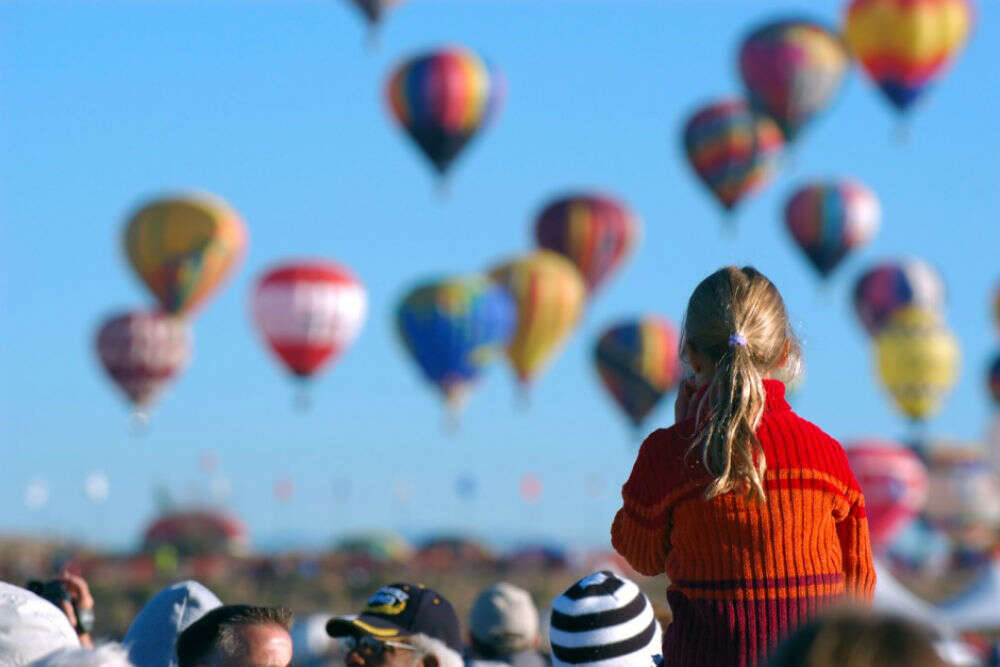 Watching hundreds of colorful hot-air balloons ascend into the dawn sky albuquerque-balloons-940x624