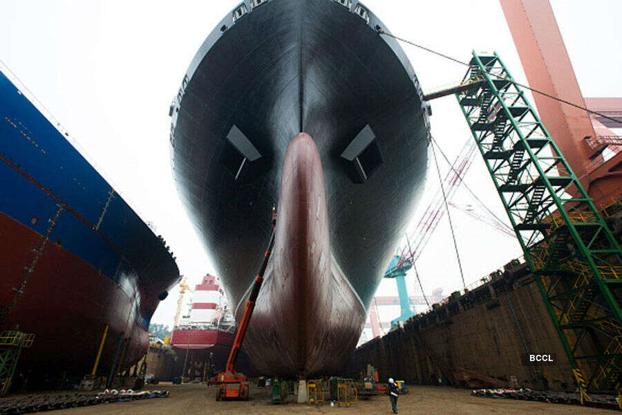 An employee walks beneath a ship