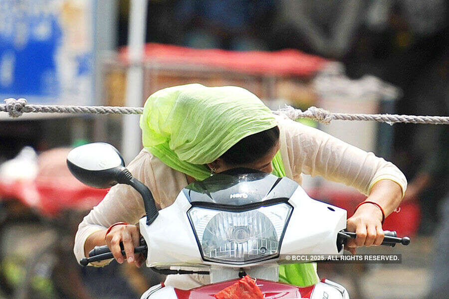 Commuters crossing the road in-front of Saket Metro station