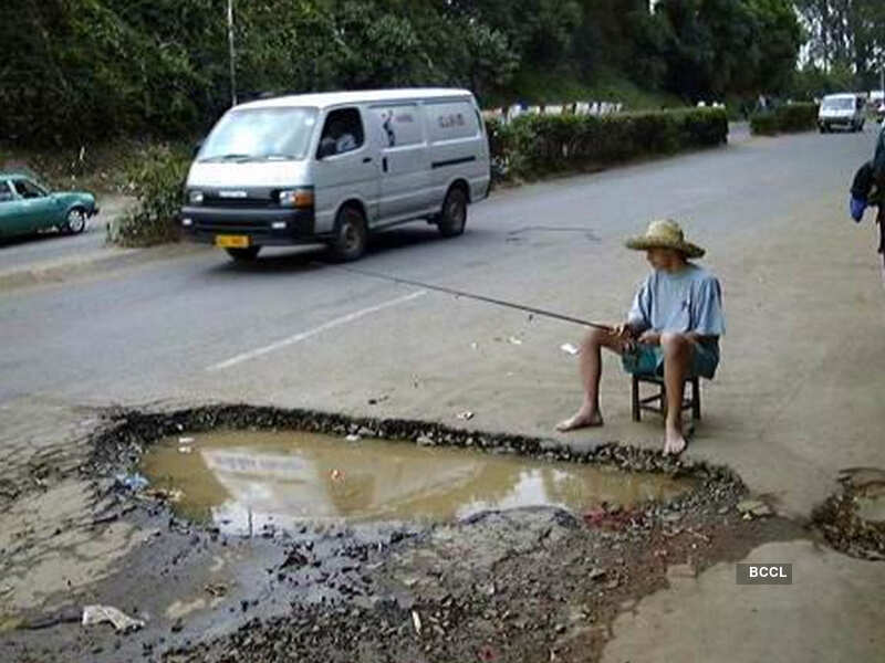 A man fishing in a pothole