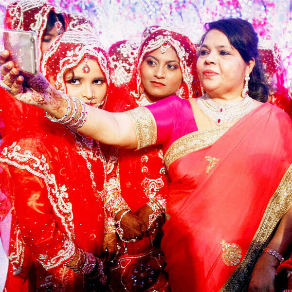 Women clicking selfie with brides