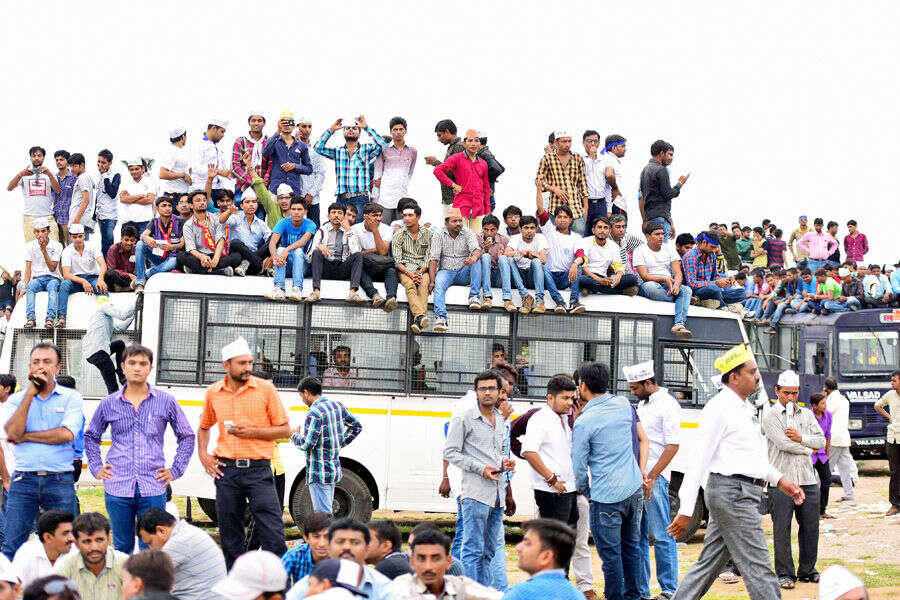 People of Patel ( Patidarl community ) seat atop a police bus