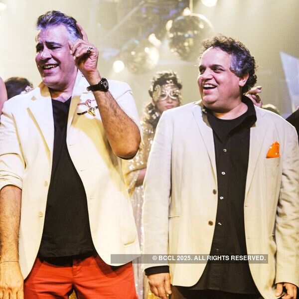 Designers Abu Jani and Sandeep Khosla walk the ramp after showcasing their creations