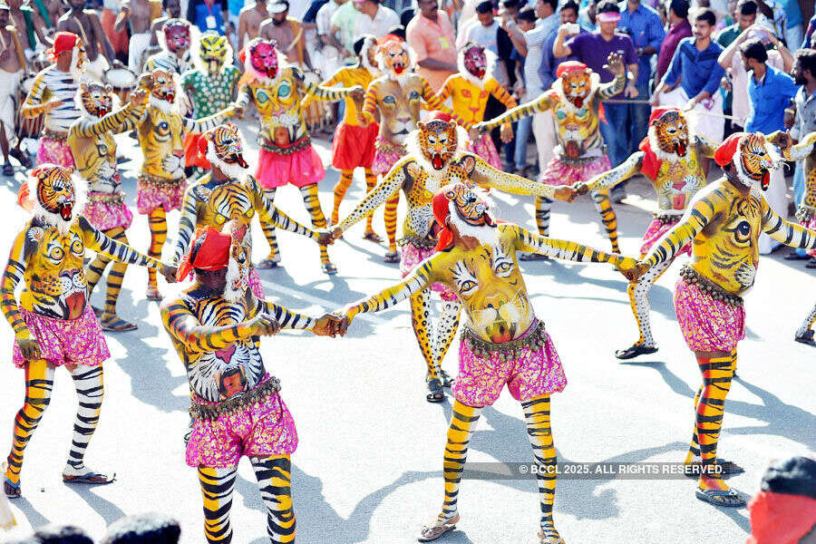 Artists with their body painted as tiger dance during the 'Pulikali'