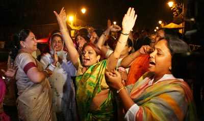 Congress supporters celebrate the passing of Women's Reservation Bill in  Rajya Sabha, outside Sonia Gandhi's residence in New Delhi on March 9, 2010  - Photogallery
