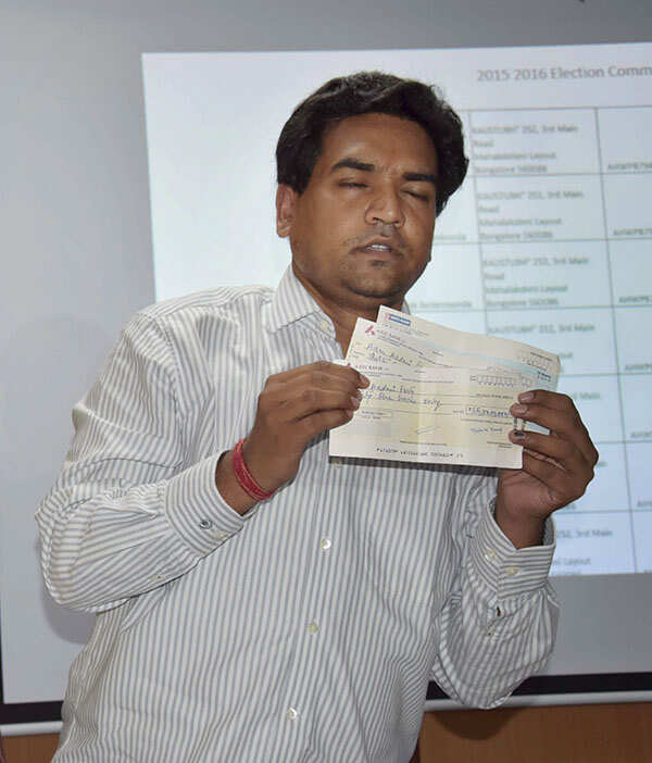 Kapil Mishra shows cheques