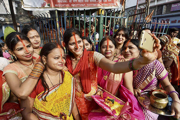 Married women pose for a selfie