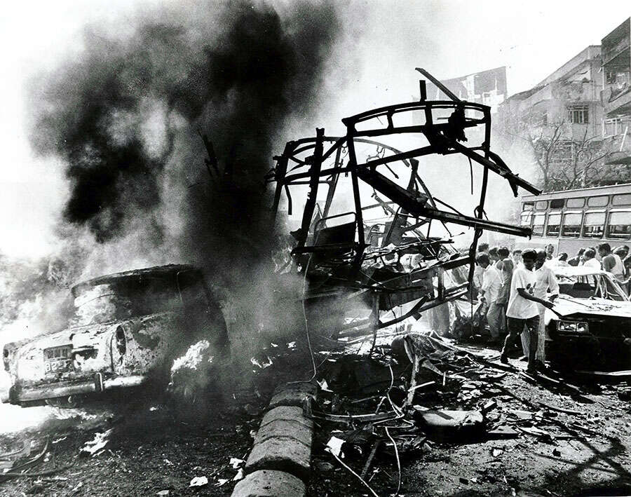 Smouldering cars and buses in the aftermath of serial blasts